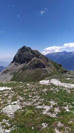 Scenic view of mountain against blue sky