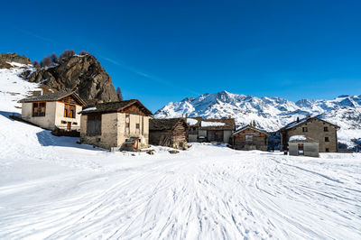 View of the village of grevasalvas, and lake sils, in engadine, switzerland, in winter.