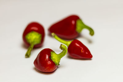 Close-up of red chili peppers on white background