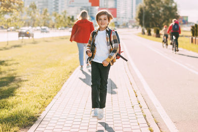 Portrait of women walking on footpath