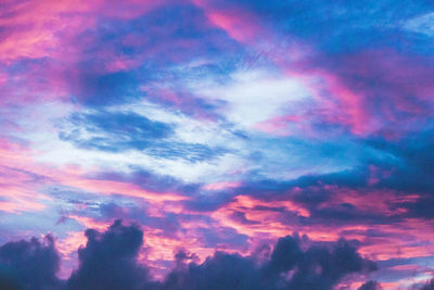 Low angle view of dramatic sky during sunset