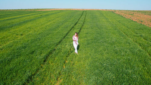 Full length of woman walking on field