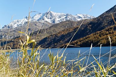 Scenic view of lake by mountains against sky