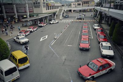 High angle view of cars and taxies on road by station