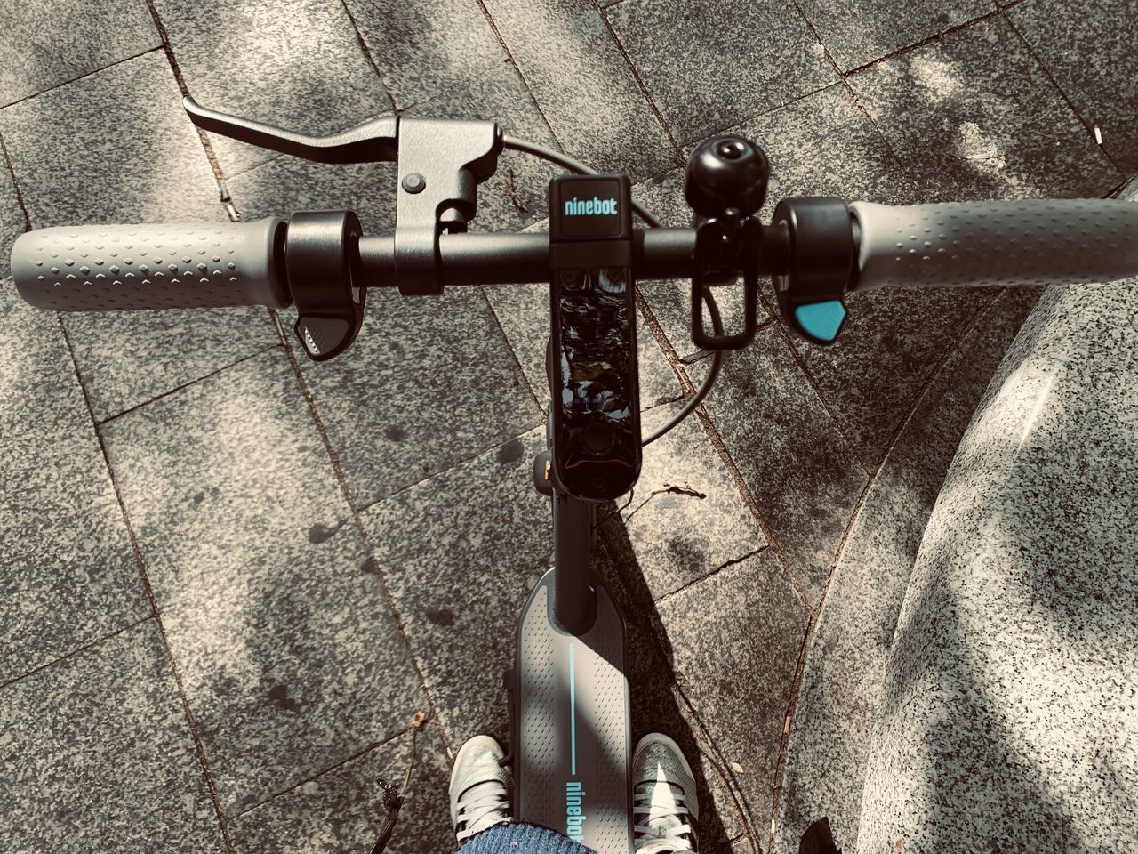 HIGH ANGLE VIEW OF PERSON RIDING BICYCLE ON STREET