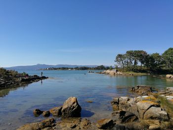 Scenic view of sea against clear blue sky