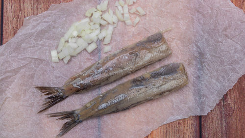 High angle view of dead fish on cutting board