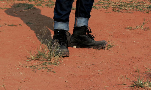 Low section of person wearing black boot