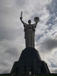 Low angle view of statue against cloudy sky