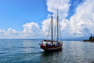 Sailboat sailing on sea against sky