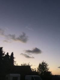 Low angle view of silhouette trees against sky