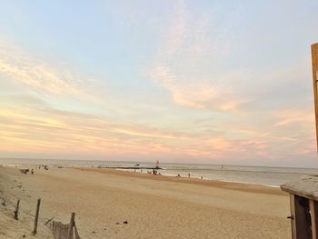 Scenic view of beach against sky during sunset