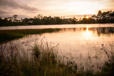 Scenic view of lake against sky during sunset