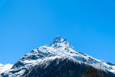 Scenic view of snowcapped mountains against clear blue sky