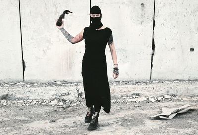 Full length of man standing against wall