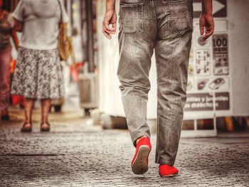 Low section of man standing on street