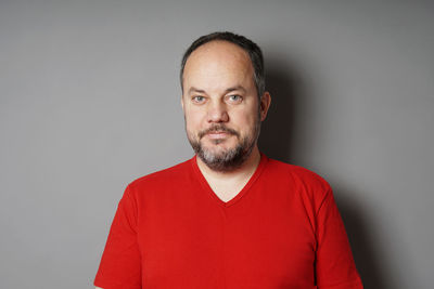 Portrait of mid adult man against white background