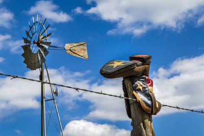 Low angle view of windmill against sky