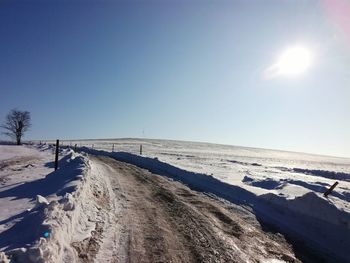 Scenic view of beach against sky during winter