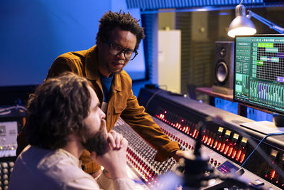 Side view of woman using sound mixer