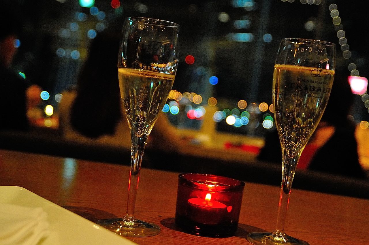 indoors, illuminated, glass - material, table, transparent, close-up, focus on foreground, night, still life, lighting equipment, decoration, no people, drinking glass, selective focus, food and drink, glass, christmas, window, wineglass, drink