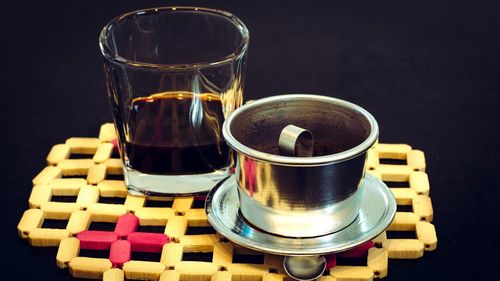 Close-up of drink on table against black background