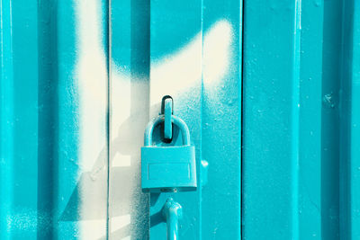 Blue padlock on blue and white door