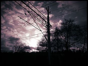 Low angle view of silhouette trees against sky