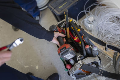 High angle view of female technician with electrical tools