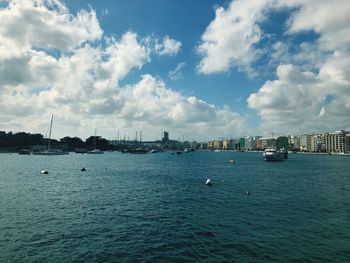 Sailboats in sea against sky