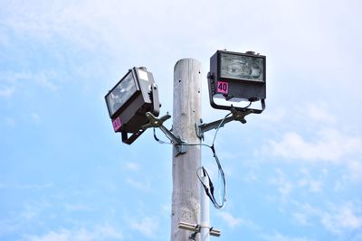 Low angle view of telephone pole against sky