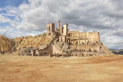 View of old ruin building against cloudy sky