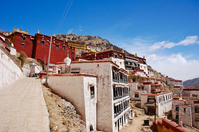 Old town by buildings in city against sky