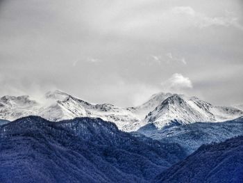 Scenic view of snowcapped mountains against sky