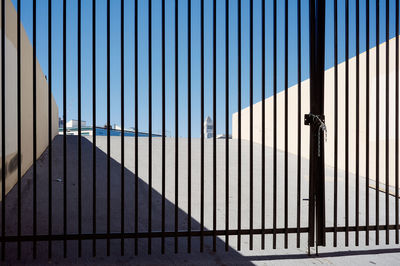 Metal fence against modern building in the background