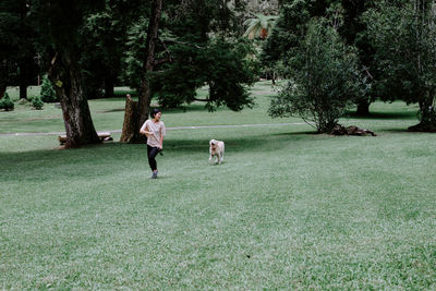 Woman and dog on field