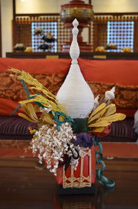 Close-up of white flowers on table against building