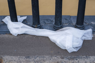 Close-up of white umbrella on footpath