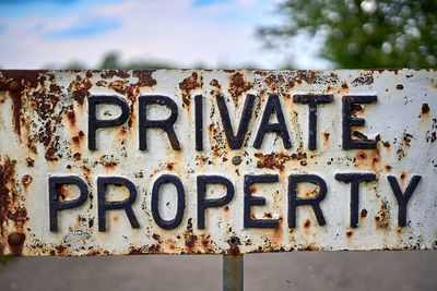 Close-up of text on rusty metal