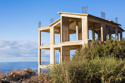 Low angle view of abandoned building against blue sky