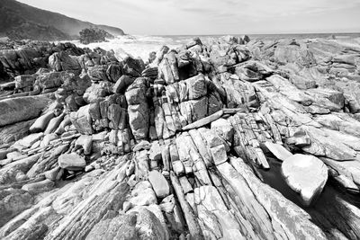 Panoramic view of rocks on beach against sky