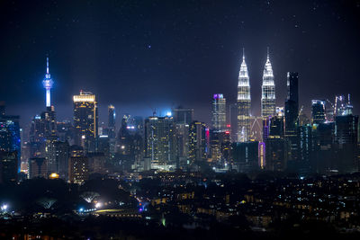 Aerial view of illuminated buildings in city at night