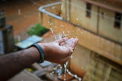 Close up of rain droplets on hand