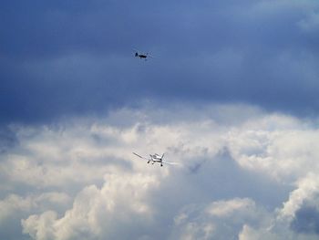 Low angle view of airplane flying against sky