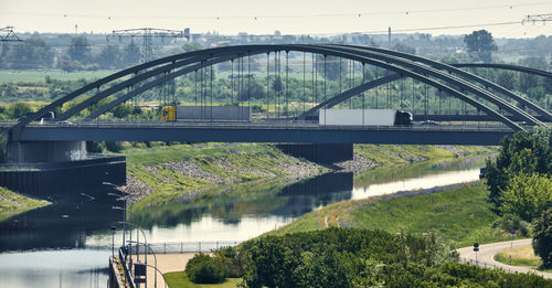 Arch bridge of the motorway over the elbe near magdeburg with trucks and traffic