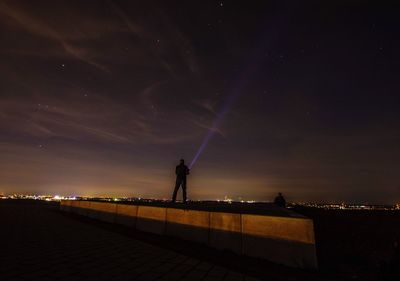 Man standing against sky at night