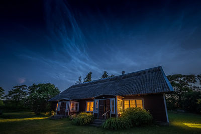 House on field against sky at dusk