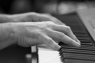 Midsection of man playing piano