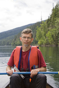 Portrait of mature man canoeing on lake at wells gray provincial park