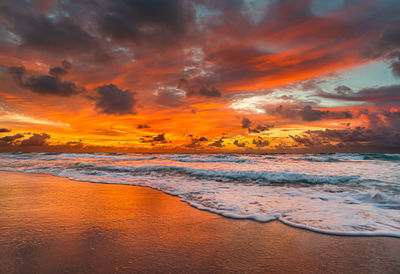 Scenic view of beach against sky during sunset